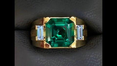 18k men's ring with 11x11mm Chatham created Asscher cut emerald and aqua spinel baguette sides.