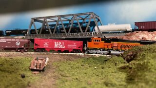 N scale BNSF ballast train backing out of a rural line.