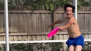 Boy throws frisbee in mom's face