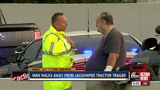 Man walks away from jackknifed tractor trailer