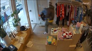 Thief Casually Walks Out Of Store With A Pile of Clothes