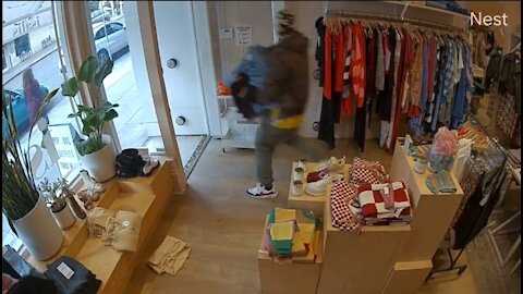 Thief Casually Walks Out Of Store With A Pile of Clothes