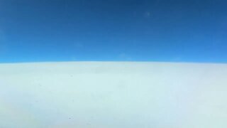 Time lapse video of flying on top of the clouds.
