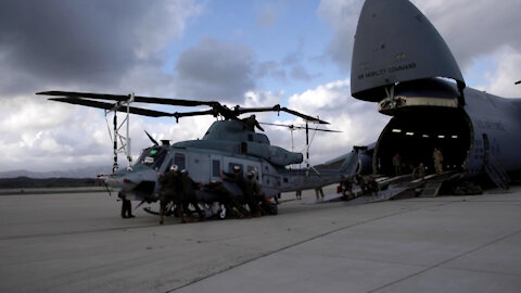 Marines, airmen load helicopters into Super Galaxy for deployment