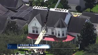 Crane crashes into house