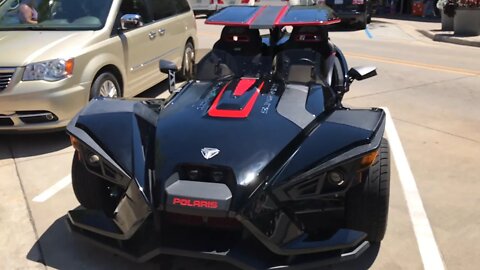 Just a black Polaris Slingshot with the optional roof and windscreen