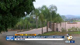 Boy with flashlight casing homes?