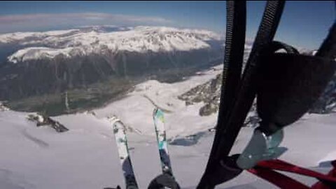Esquiador destemido salta desfiladeiro de paraquedas