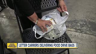 Letter carriers delivering food drive bags