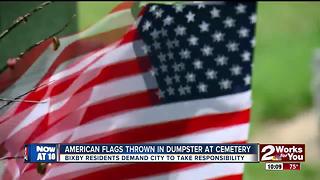 American flags thrown in dumpster