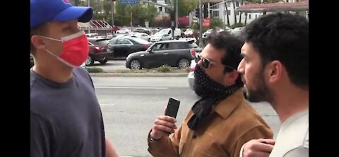 Disguised racist harrasses Jews protesting anti-Semitism