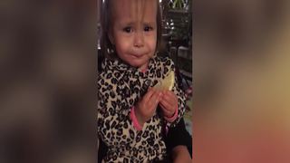 Tot Girl Bites A Slice Of Lemon