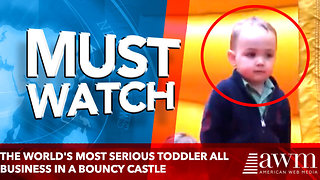 The world's most serious toddler keeps things professional in a bouncy castle