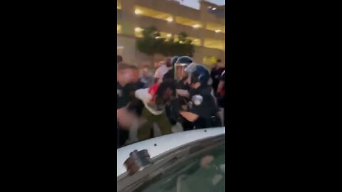 Activist being punched in the face while being held by Akron Police Department officers...