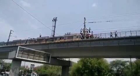 Passengers climbing on Delhi Metro, when stopped due to technical failure