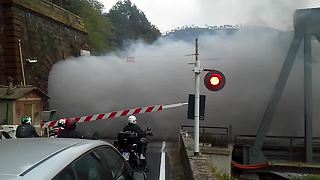 Onlookers Stand In Awe While Old-Fashioned Steam Train Crosses Bridge