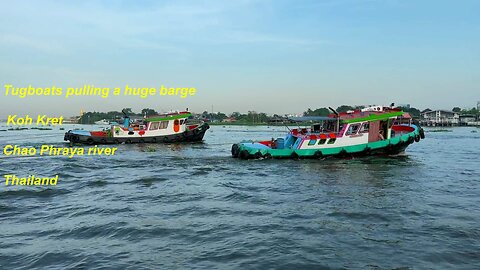 Tugboats pulling a huge barge at Koh Kret Chao Phraya river