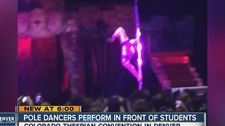 Pole dancers perform in front of students