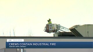 Fire crews continue to battle warehouse fire in Amherst