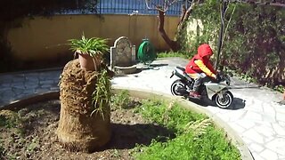 GEO KOK Junior with a motorbike in the green of the apartment complex