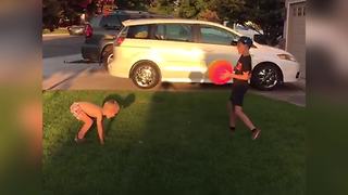 A Little Boy Fails In Catching A Large Ball