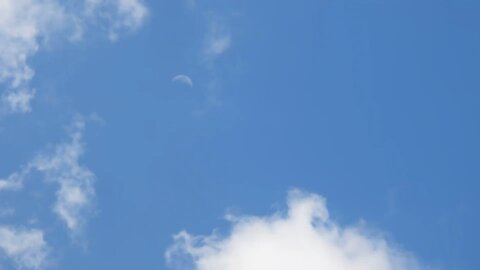 Daytime transparent moon, shining through the clouds time lapse ￼