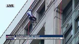 Ann Marie LaFlamme rappelling down a building