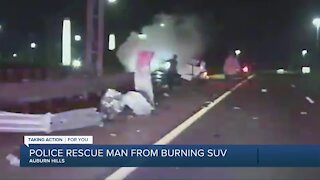 Police rescue man from burning SUV