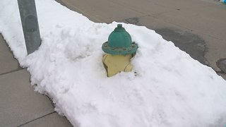 Clearing snow from around hydrants