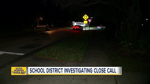 Car blows past school bus, nearly hits girls