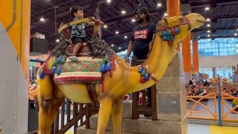 Kid riding camel