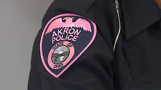 Akron police officers wearing pink patches for breast cancer awareness month
