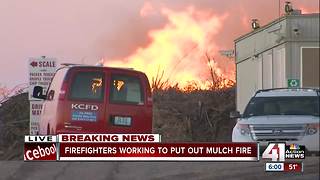 Smoke fills the sky in large mulch fire