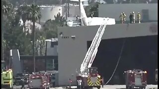 A small plane crashed nose-first into hangar building at Long Beach airport...