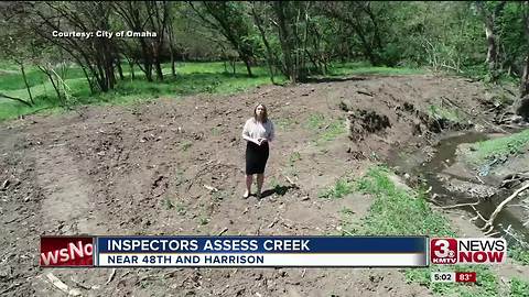 Environmental inspectors assess creek erosion