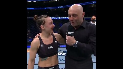 Vanessa Demopoulos jumps in Joe Rogan's arms during post fight interview.