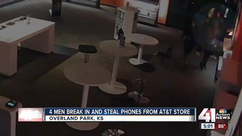 Video captures suspects busting through AT&T cell phone store, grabbing devices.