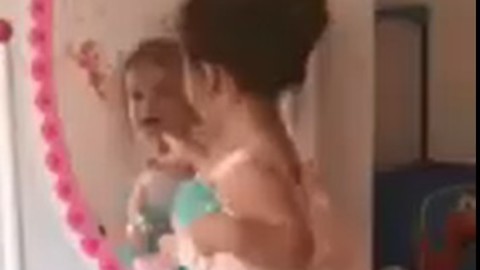 Cute Little Girl Dances and Sings in Front of the Mirror