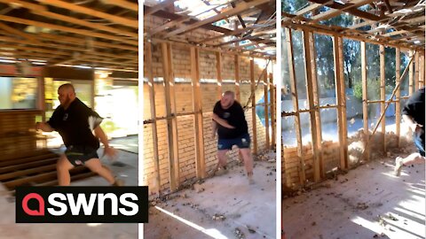 Australian tradie knocks down a brick wall by using his own body as a human WRECKING BALL