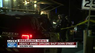 Heavily armed officers shut down street