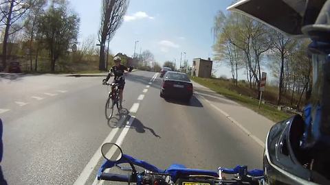 Biker randomly surprises passing cyclist with high-five