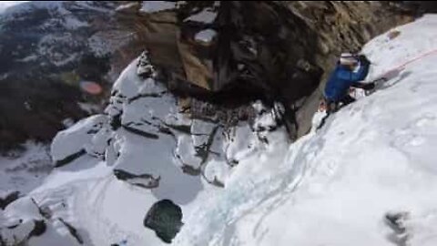 Man climbs frozen waterfall