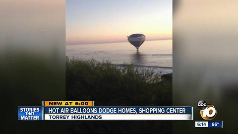 Hot air balloons dodge homes, shopping center