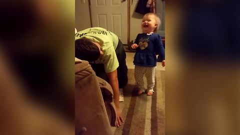 A Tot Girl Laughs As Her Dad Pretends That She Is Hitting Really Hard