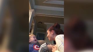 A Tot Boy Laughs When He Pushes His Mother Away
