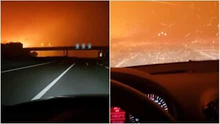 Driver goes through giant fire on the highway