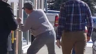 Angry man coughs, spits, and licks to contaminate door handle