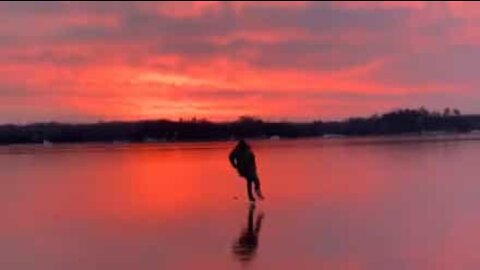 Scenic winter sunset on frozen lake