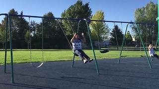 A Young Girl Jumps Off A Swing And Ends Up On The Ground