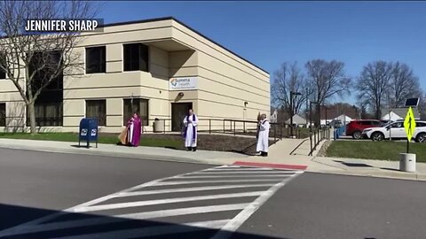 Priests recite prayer outside Barberton hospital for those on the frontlines of COVID-19 pandemic